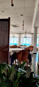 a dining room with a table and a cross on the ceiling at Hotel Altaia in Altea