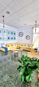 a living room with couches and tables and a plant at Hotel Altaia in Altea