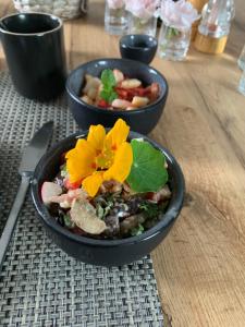 two bowls of food sitting on a wooden table at B&B L'Echappée Belle in Falaën