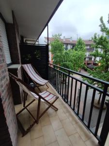 a chair sitting on a balcony with a view at Sagasti in Astigarraga