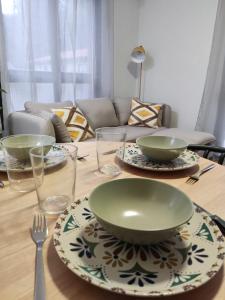 a wooden table with plates and bowls and glasses on it at Sagasti in Astigarraga