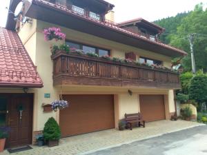 a balcony on a house with a bench on it at Apartmán Donovaly Mišuty 586 in Donovaly