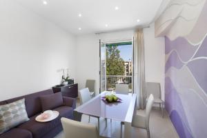 a living room with a purple couch and a table at Estate4home - L'onda viola in Sorrento