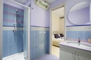 a bathroom with a shower and a sink and a mirror at Estate4home - L'onda viola in Sorrento +26 photos