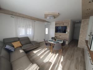 a living room with a couch and a table at Stella Maris in Kaštela