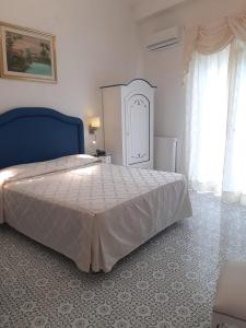 Cama ou camas em um quarto em Hotel La Perla