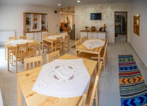 a dining room with wooden tables and chairs at Poiana Brazilor in Borşa