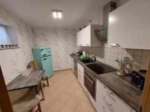 a kitchen with a green refrigerator and a table at Ferienwohnung Waldblick in Brilon +4 photos