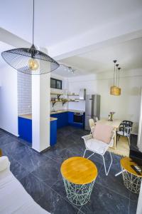 a kitchen and living room with a table and chairs at Gorgeous Apartment in the city center in Thessaloniki