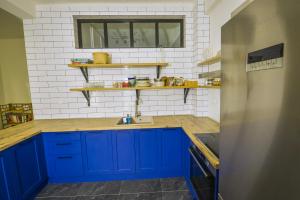 a kitchen with blue cabinets and a sink at Gorgeous Apartment in the city center in Thessaloniki