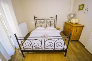 a bedroom with a bed and a dresser with a fan at Gorgeous Apartment in the city center in Thessaloniki