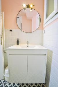 a bathroom with a white sink and a mirror at Gorgeous Apartment in the city center in Thessaloniki