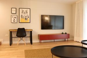 a living room with a flat screen tv on the wall at AD Loft apartment, Centro Cambados in Cambados