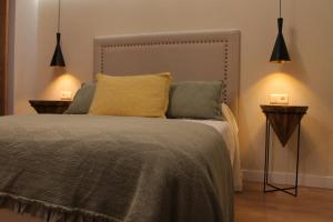 a bedroom with a bed with two night stands and two lamps at AD Loft apartment, Centro Cambados in Cambados