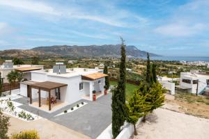 an aerial view of a white house with mountains in the background at Alta Vista 2 Luxury House in Kardamaina