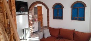a living room with a couch and two windows at Apartments Daut's Tower in Sarajevo