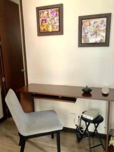 a desk in a room with a chair and a phone at Fantástica Habitación Privada Colina in Bogotá