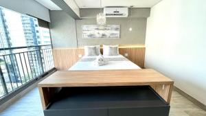 a bedroom with two beds and a balcony at Haus Stay . Luxo . Vitralli Moema in Sao Paulo