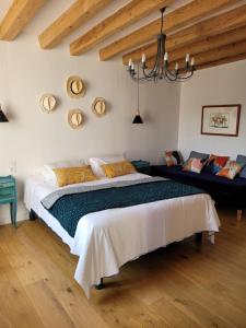 a bedroom with a large bed and a chandelier at Bulle de campagne à Saint Benoit la Forêt in Saint-Benoît-la-Forêt