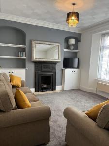 a living room with a couch and a fireplace at Town House,Walking Distance To Town,Beach,Harbour. in Torquay