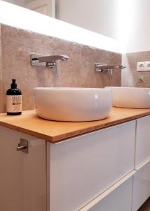a bathroom with two sinks on a counter at PEMATRA Haus Waterkant - FeWo Koje in Travemünde