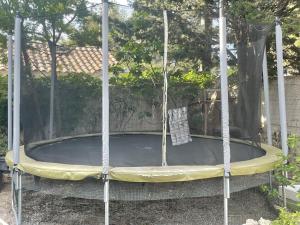 a trampoline with a swing in a yard at Appartement spacieux et lumineux Calanques Sormiou in Marseille