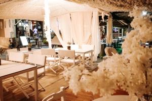 a restaurant with white tables and white chairs at Limenaria Beach in Limenaria +93 photos