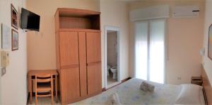 Posteľ alebo postele v izbe v ubytovaní Hotel Amalfi