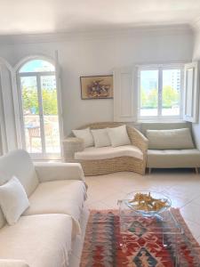 a living room with two couches and a table at Vilamoura City Center Flat in Vilamoura