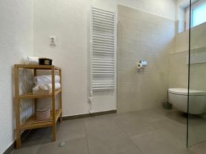 a bathroom with a toilet and a glass shower at City Apartments in Liptovský Mikuláš +41 photos