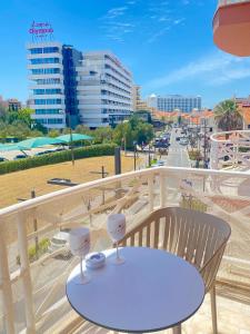 a table on a balcony with a view of a city at Vilamoura City Center Flat in Vilamoura