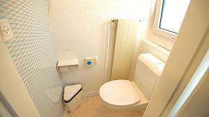 a small bathroom with a toilet and a sink at Budgetapartment Seealpsee von Swisspartments in Arbon