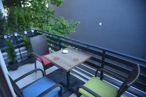 a table and chairs on a balcony with a table at Dekart Apartment in Niš