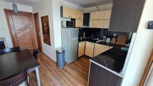 a small kitchen with a refrigerator and a counter top at Magic Sea View in Tsarevo