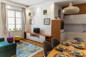 a kitchen and dining room with a table and chairs at Top location CITY CENTRE CONDO in historic building with free garage PARKING in Ljubljana