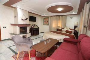 a hotel room with a bed and a couch at Equi Palace & SPA Near Aeroport in Berrechid