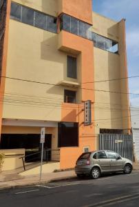 a car parked in front of a building at Shalon Hotel in Uberaba