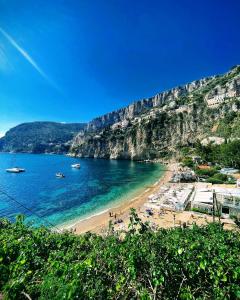 a view of a beach with boats in the water at Hotel Normandy in Cap d'Ail