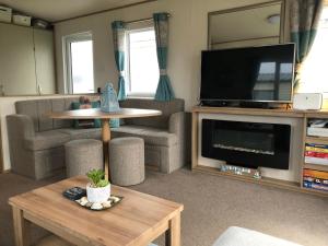 a living room with a couch and a tv and a table at Pebble Ridge hoilday home in Northam
