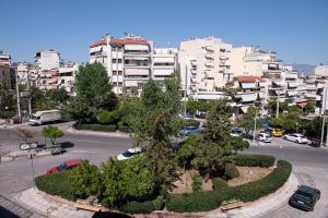 a city with a park with trees and buildings at Sophia’s place in Piraeus