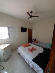 a bedroom with a bed and a ceiling fan at Shalon Hotel in Uberaba