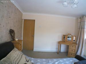 a bedroom with a bed and a wooden table at 1 bedroom Annex in the heart of Amman Valley in Bettws
