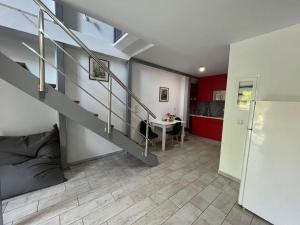 a living room with a staircase and a kitchen at Villa Perivoli in Parga