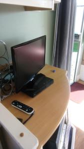 a computer monitor sitting on top of a desk at River Views Dog friendly caravan 3 bedrooms in Rye