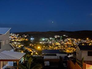 a view of a city at night with lights at L'Eté sans fin, vue mer in Filaos