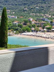 a view of a beach from a balcony at Lighthouse Apartments in Stoupa