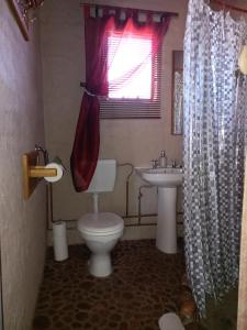 a bathroom with a toilet and a sink at Five Pebbles on Piece of Africa in Cullinan