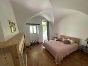 a bedroom with a bed and an arched ceiling at La Genevraie in Gap