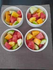 four bowls filled with different fruits in them at Salmiya Place 2 in Nairobi