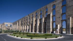 a large stone building with arches and a road at Cozy apartment Elvas1 in Elvas